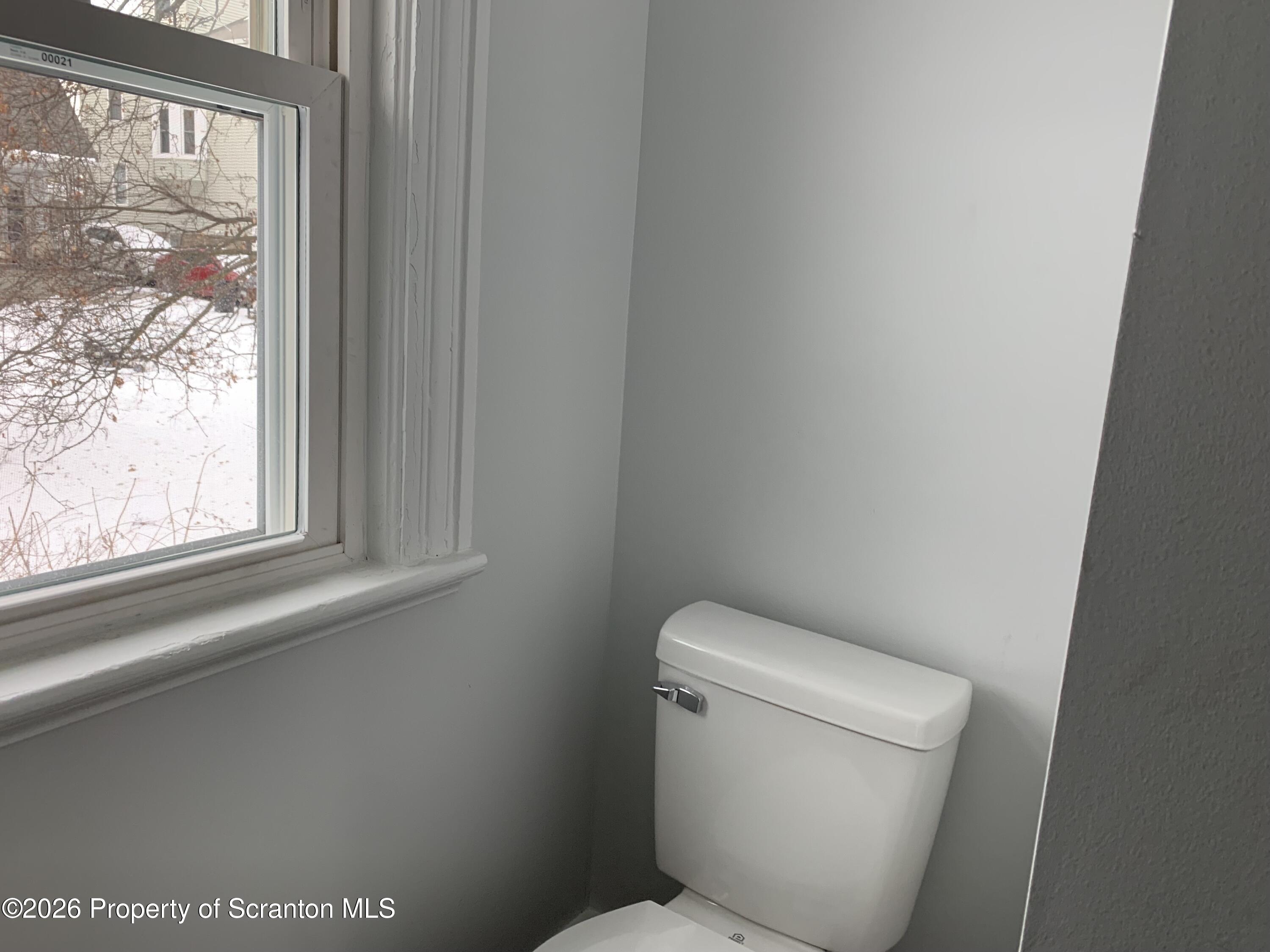709 Meade Street Dunmore, PA 18512 - Photo 10 of 38 a white toilet sitting next to a window
