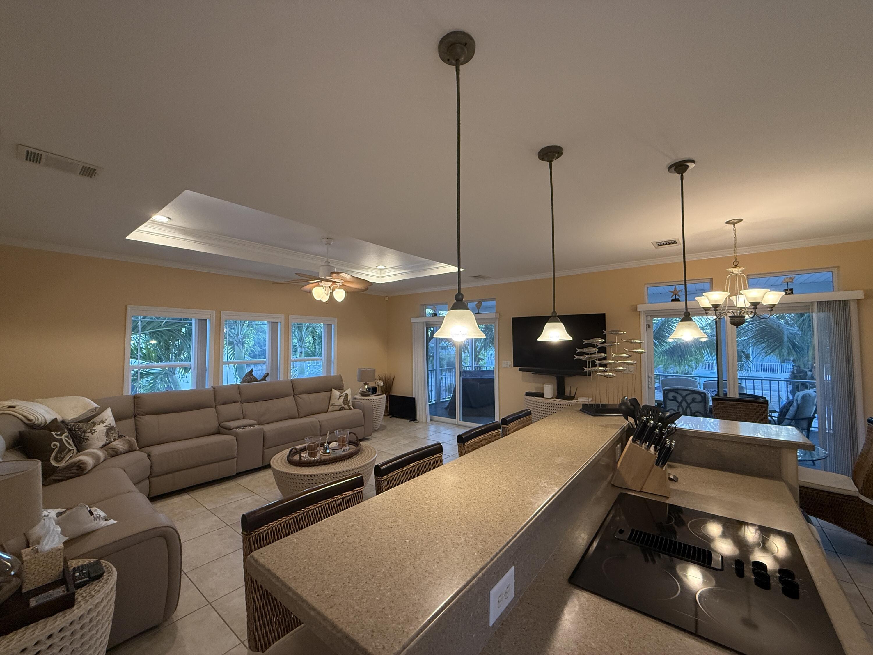 903 Tropical Lane Key Largo, FL 33037 - Photo 12 of 46 a large room with furniture and a wooden floor