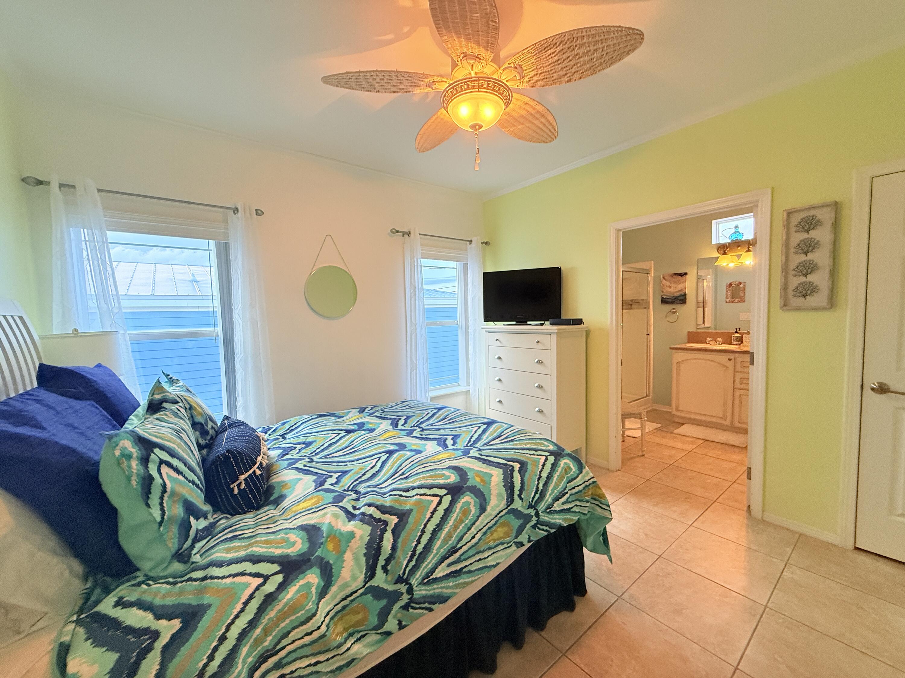 903 Tropical Lane Key Largo, FL 33037 - Photo 16 of 46 a bedroom with a bed and a chandelier