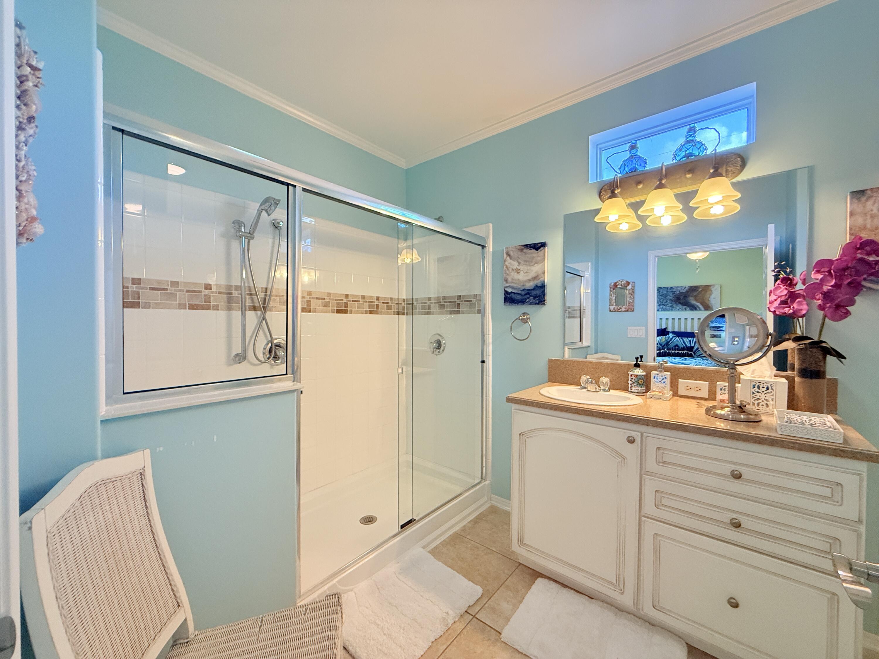 903 Tropical Lane Key Largo, FL 33037 - Photo 18 of 46 a bathroom with a granite countertop sink mirror and a shower