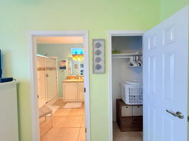 a bedroom with a bed a flat screen tv and a mirror