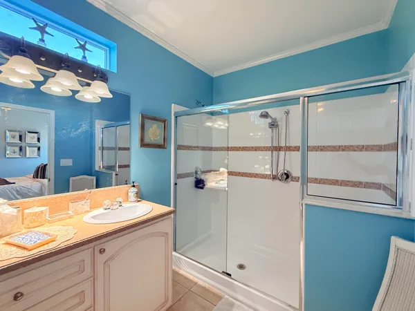 a bedroom with a bed and a lamp with the bathroom