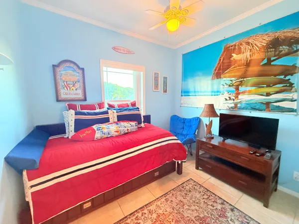 a bedroom with a bed and a flat screen tv