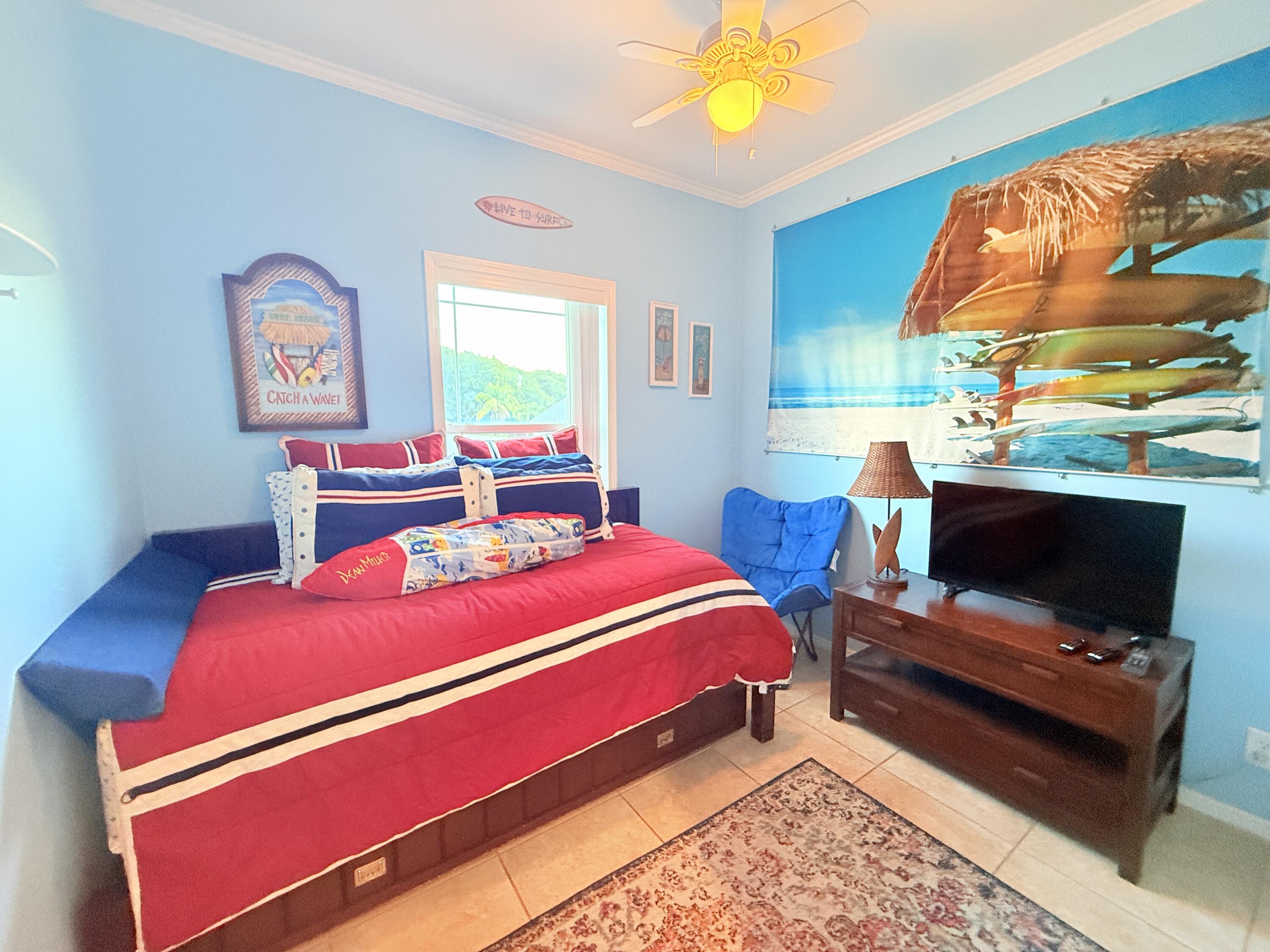 903 Tropical Lane Key Largo, FL 33037 - Photo 23 of 46 a bedroom with a bed and a flat screen tv