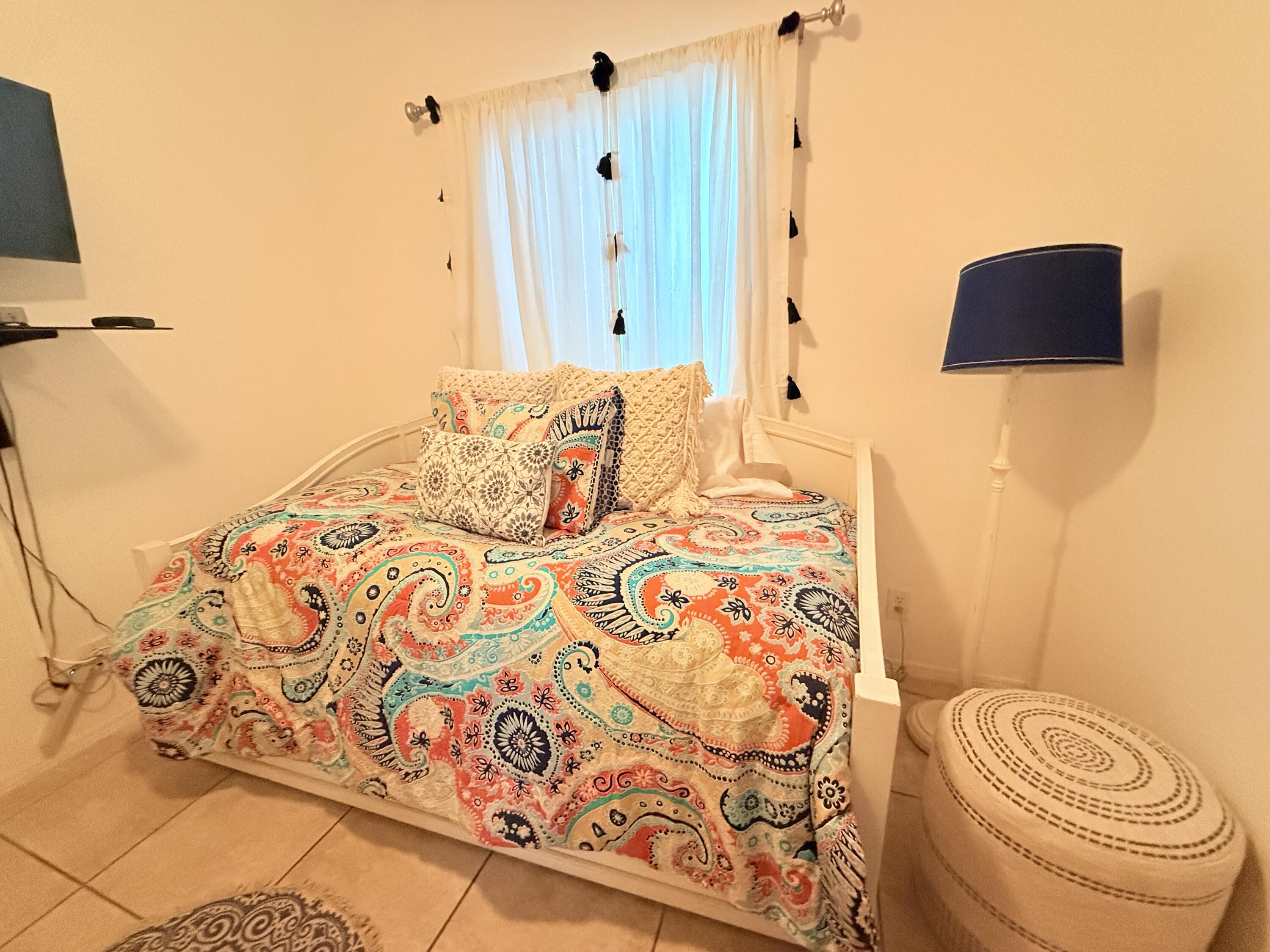 903 Tropical Lane Key Largo, FL 33037 - Photo 24 of 46 a bedroom with a bed and a lamp with the bathroom