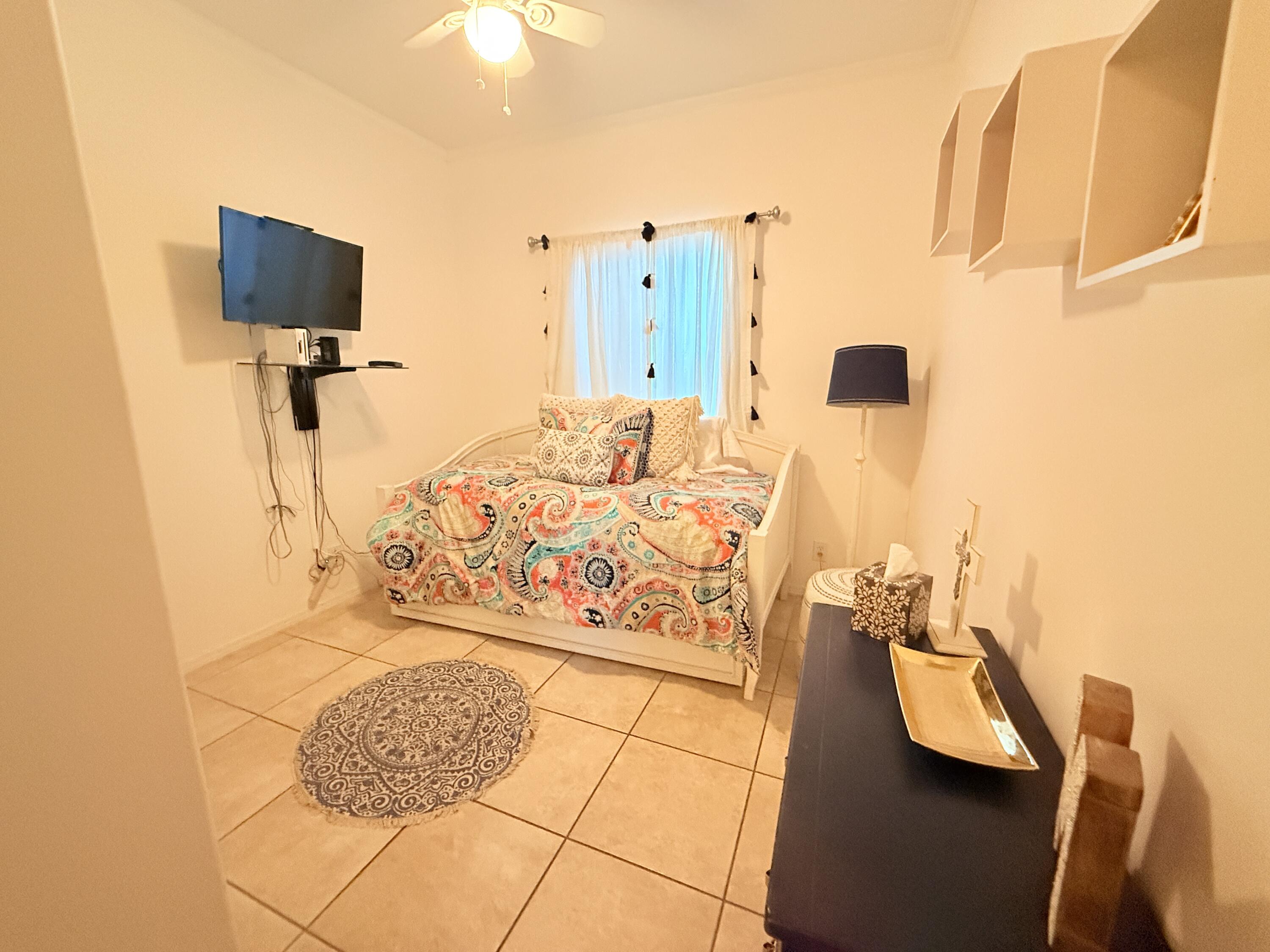 903 Tropical Lane Key Largo, FL 33037 - Photo 25 of 46 a bedroom with a bed and a flat screen tv