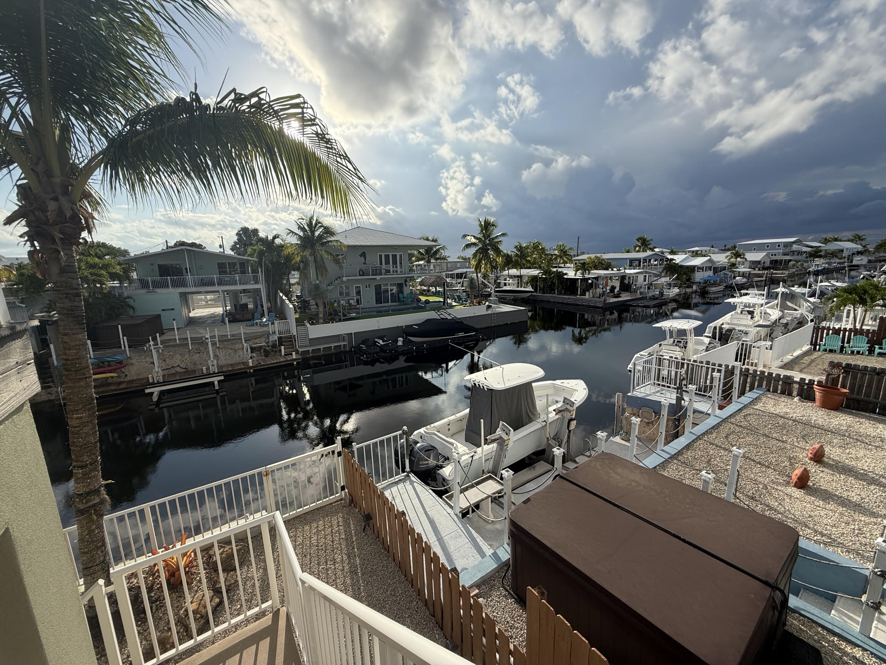 903 Tropical Lane Key Largo, FL 33037 - Photo 33 of 46 a view of a roof deck with couches and wooden floor