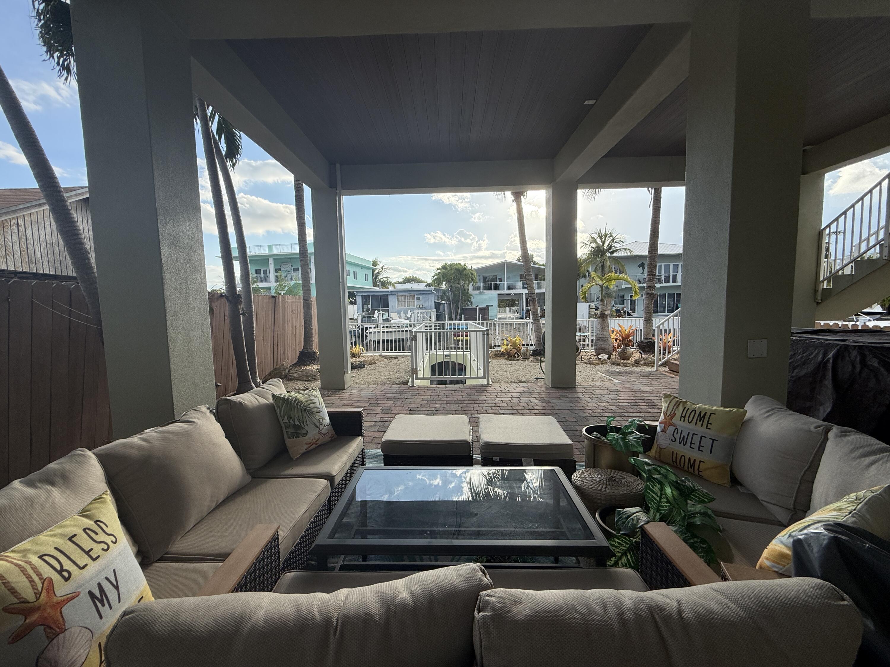 903 Tropical Lane Key Largo, FL 33037 - Photo 36 of 46 a living room with furniture and a floor to ceiling window