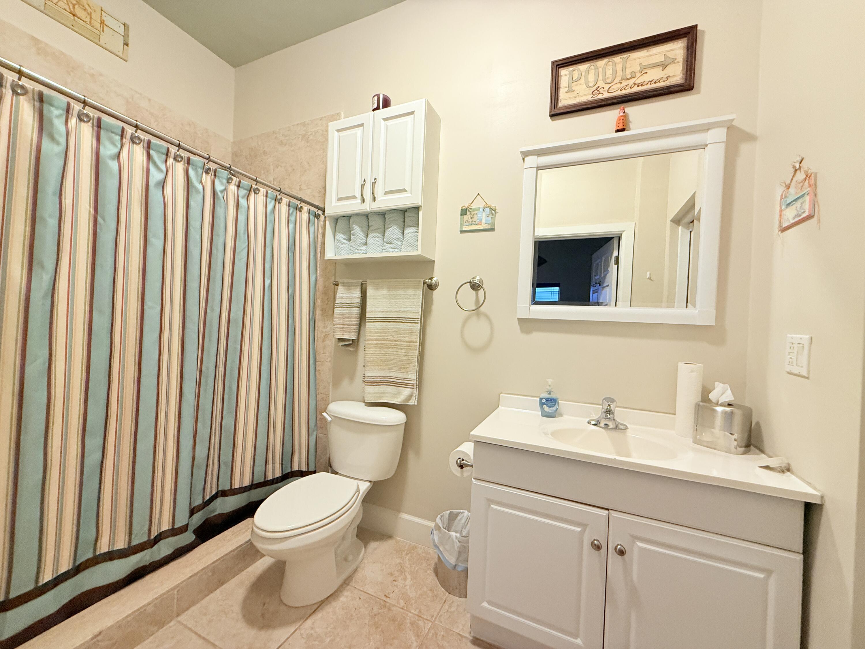 903 Tropical Lane Key Largo, FL 33037 - Photo 43 of 46 a bathroom with a toilet a sink and a mirror