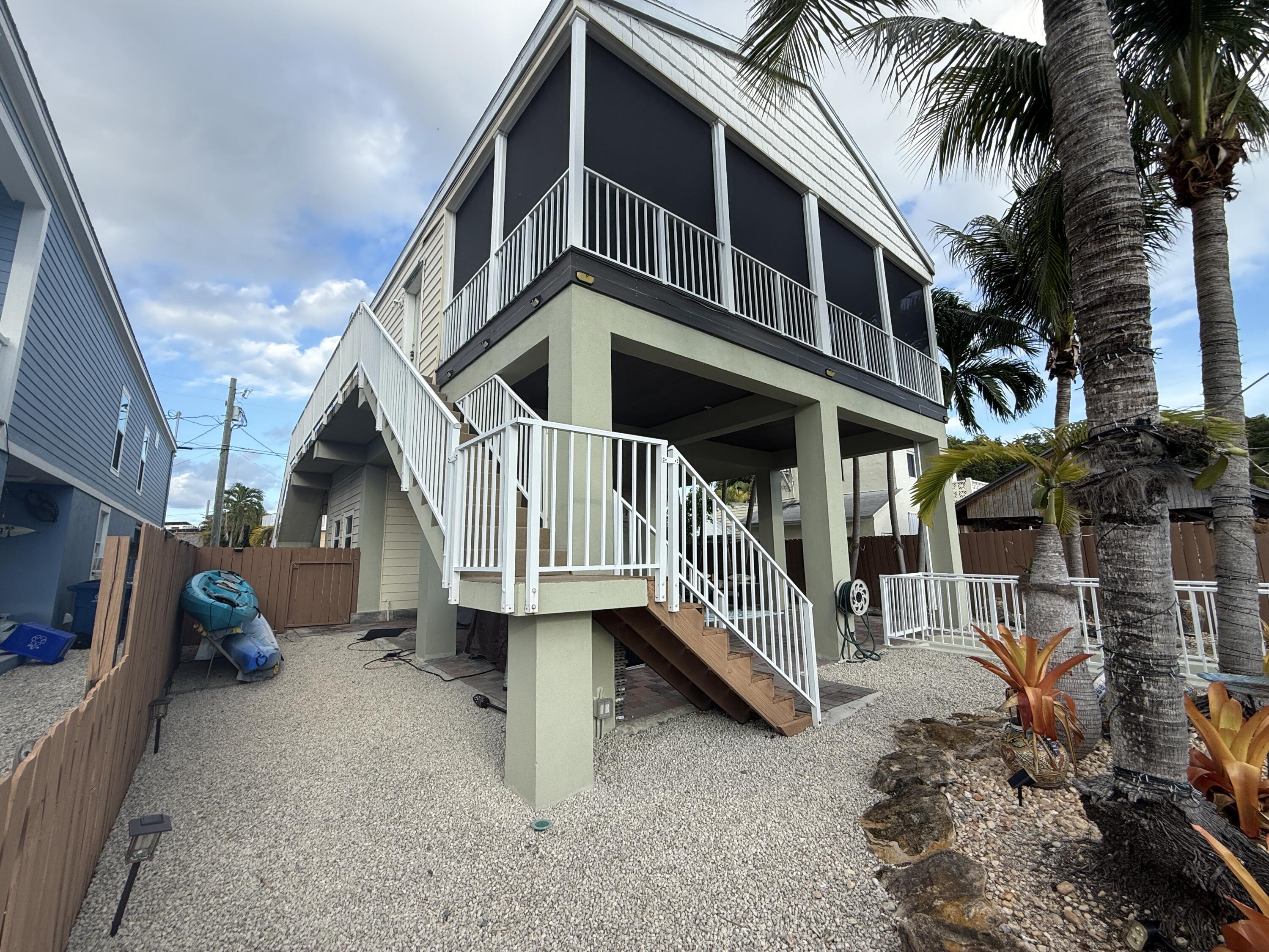 903 Tropical Lane Key Largo, FL 33037 - Photo 5 of 46 a front view of a house with balcony