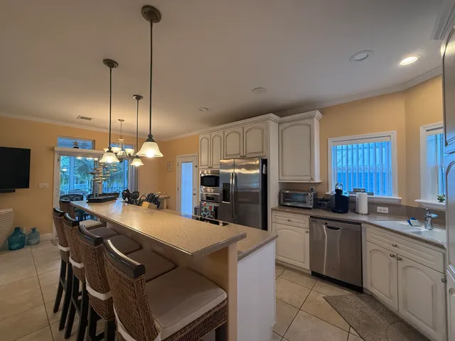 a kitchen that has a lot of cabinets in it and appliances