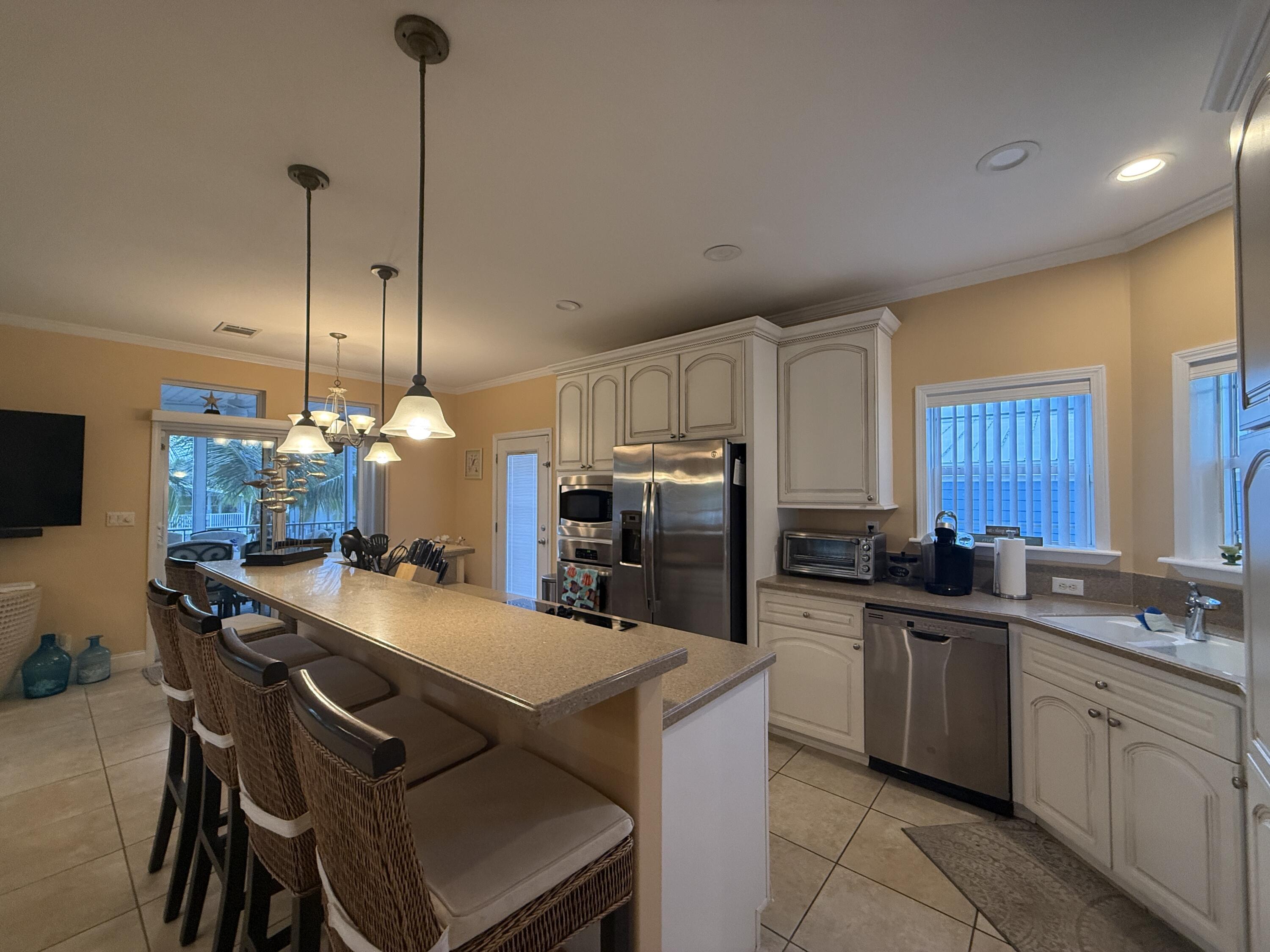 903 Tropical Lane Key Largo, FL 33037 - Photo 9 of 46 a kitchen that has a lot of cabinets in it and appliances