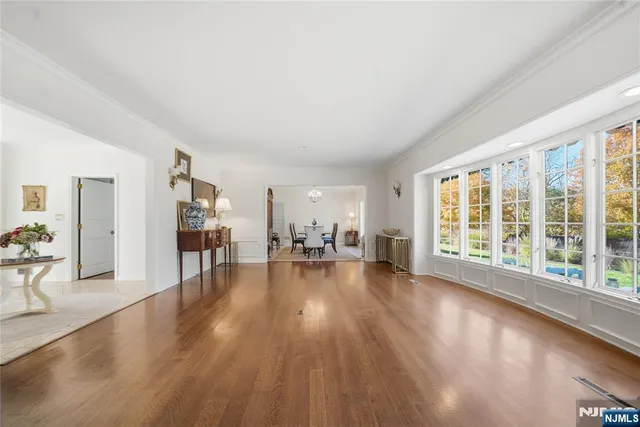 a view of empty room with fireplace and wooden floor