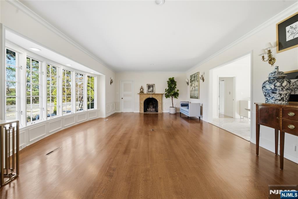 18 Pepperidge Tree Terrace Butler, NJ 07405 - Photo 12 of 35 a view of empty room with fireplace and wooden floor