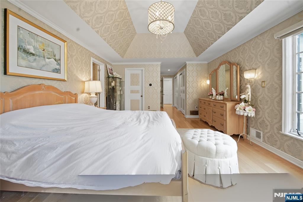 18 Pepperidge Tree Terrace Butler, NJ 07405 - Photo 25 of 35 a spacious bedroom with a bed a mirror and furniture