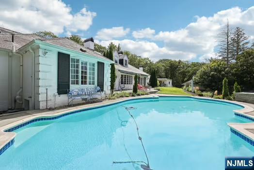 18 Pepperidge Tree Terrace Butler, NJ 07405 - Photo 35 of 35 a view of a house with swimming pool and porch