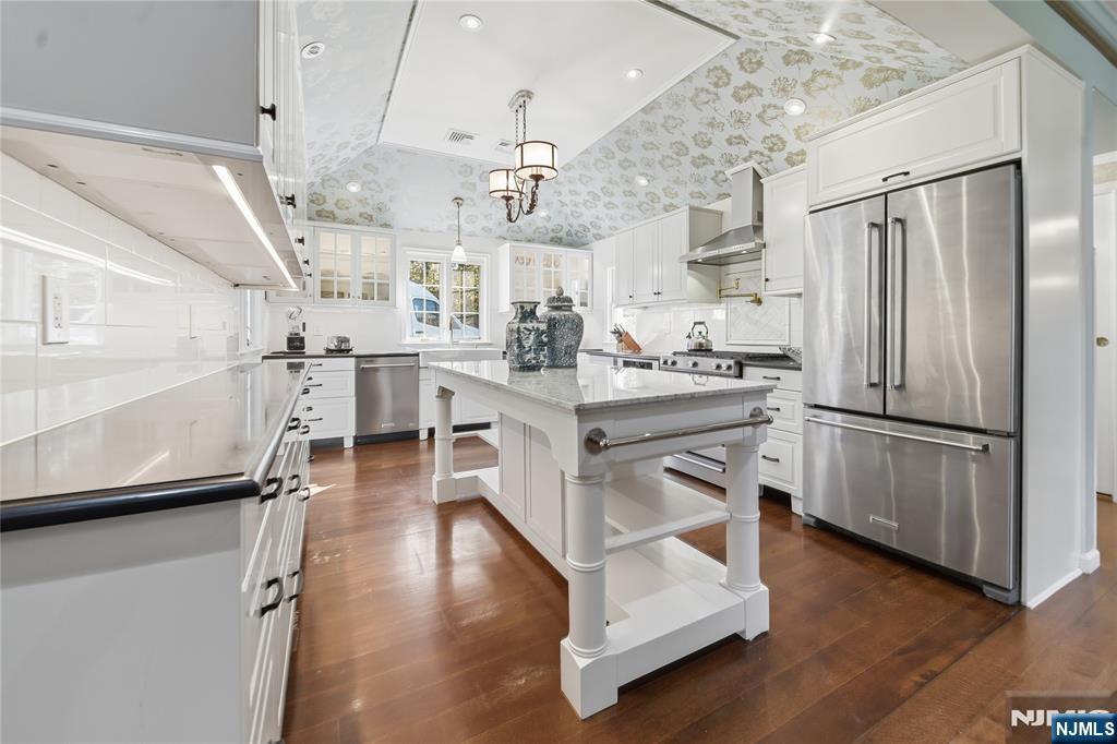 18 Pepperidge Tree Terrace Butler, NJ 07405 - Photo 6 of 35 a kitchen with stainless steel appliances a stove a refrigerator and a view of living room