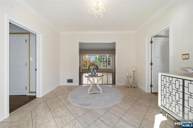 a view of a living room with furniture and wooden floor