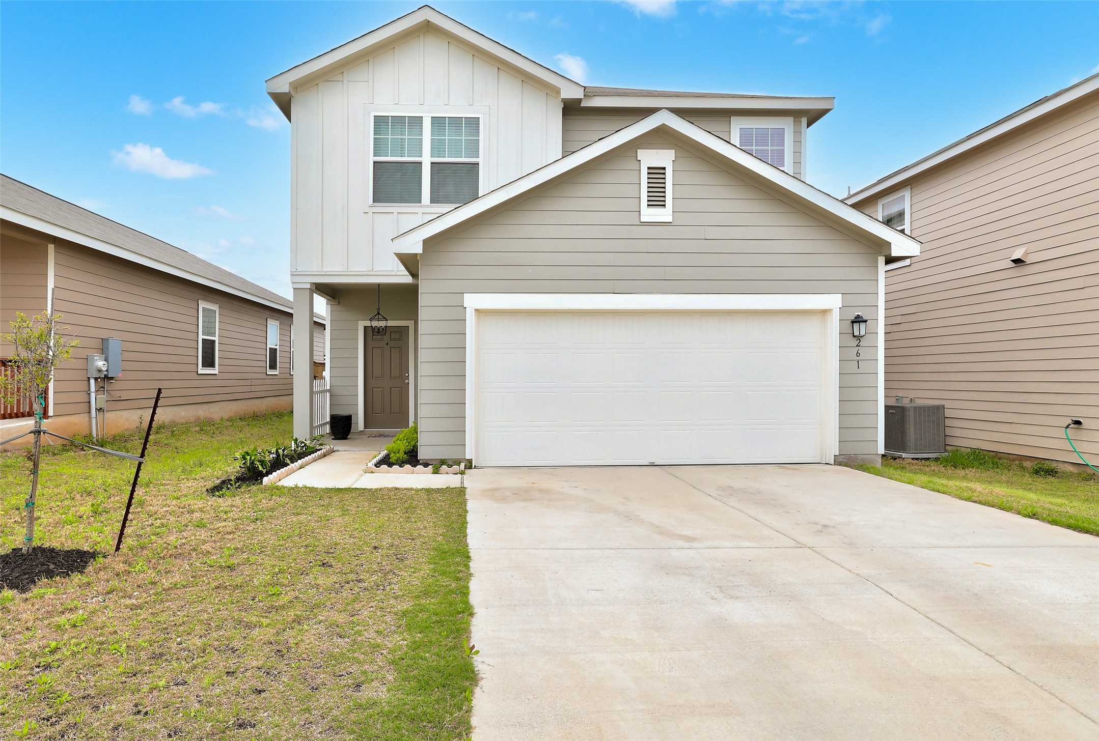 261 Night Riders Way Jarrell, TX 76537 - Photo 1 of 6 A welcoming facade showcases a spacious garage and a neatly maintained lawn, perfect for curb appeal.