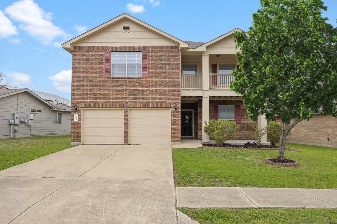 a front view of a house with a yard and garage