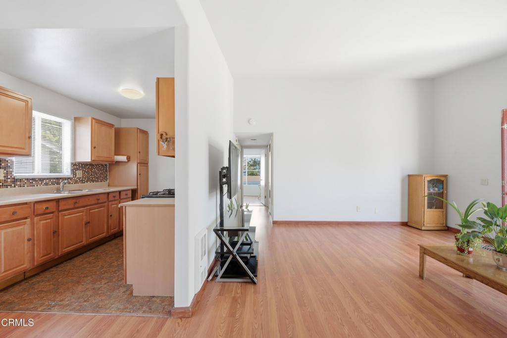 5154 Jefferson Square Oxnard, CA 93033 - Photo 13 of 23 a kitchen with granite countertop a stove a sink and a refrigerator