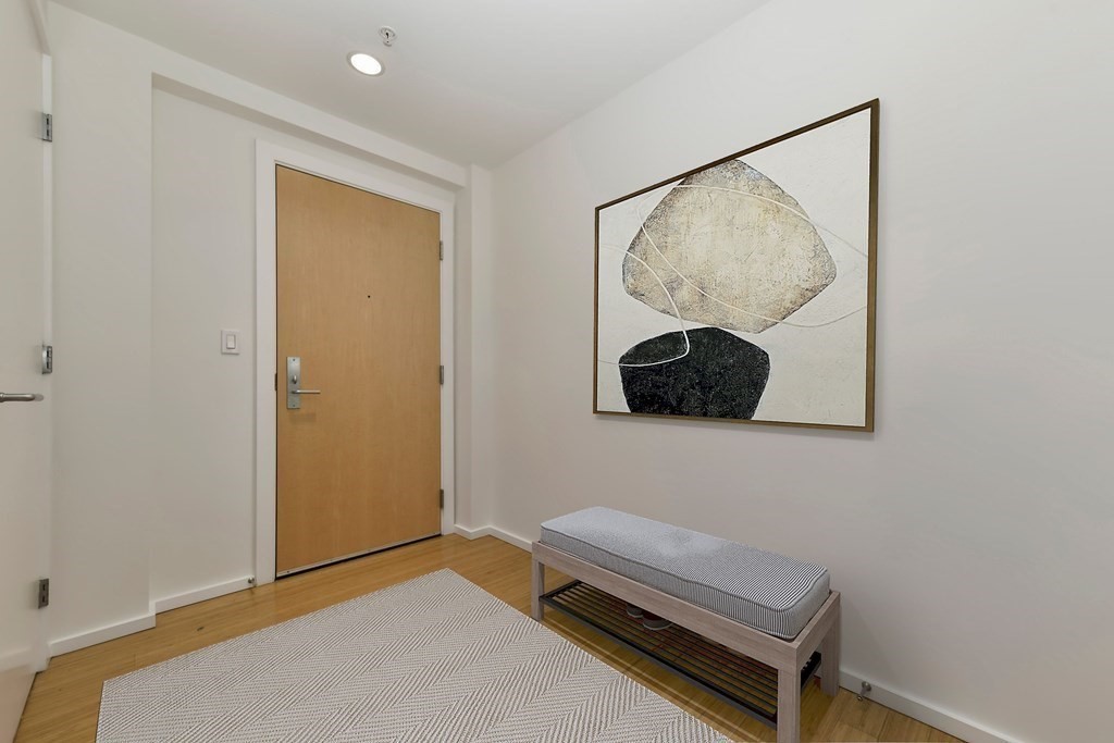 2 Earhart Street, Unit 120 Cambridge, MA 02141 - Photo 13 of 42 a living room with a couch and a painting on the wall