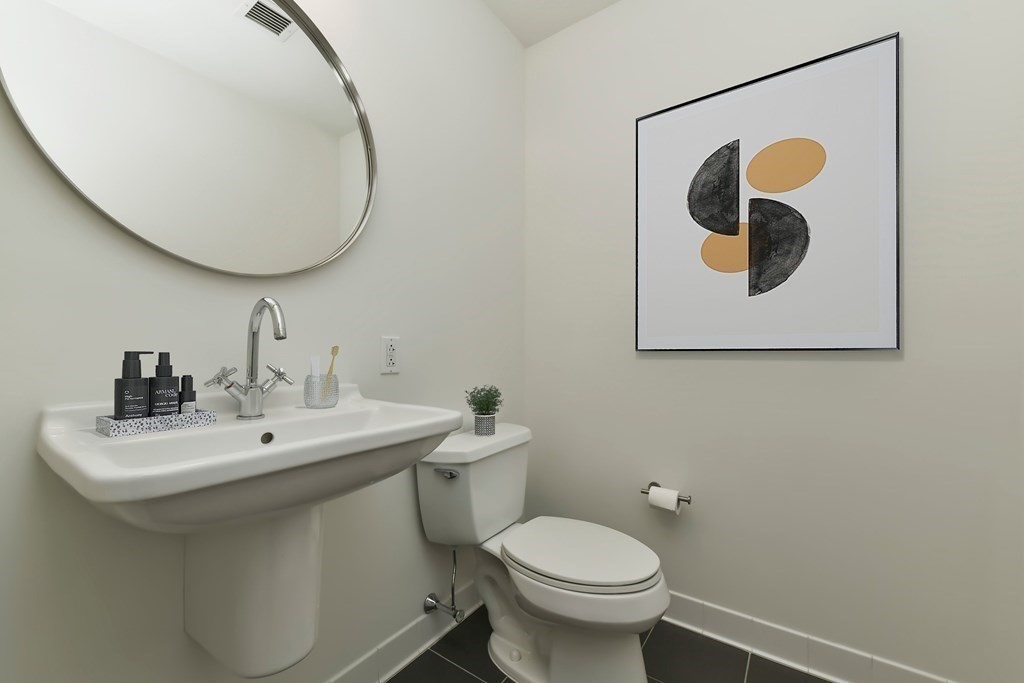 2 Earhart Street, Unit 120 Cambridge, MA 02141 - Photo 14 of 42 a bathroom with a toilet sink and mirror