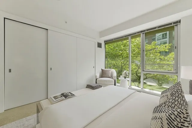 a bedroom with furniture and a large window