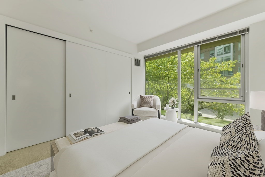 2 Earhart Street, Unit 120 Cambridge, MA 02141 - Photo 15 of 42 a bedroom with a bed and a large window