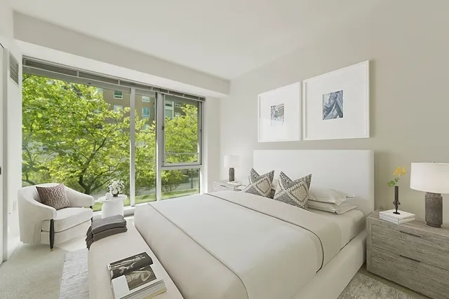 a bedroom with a bed and a painting on the wall