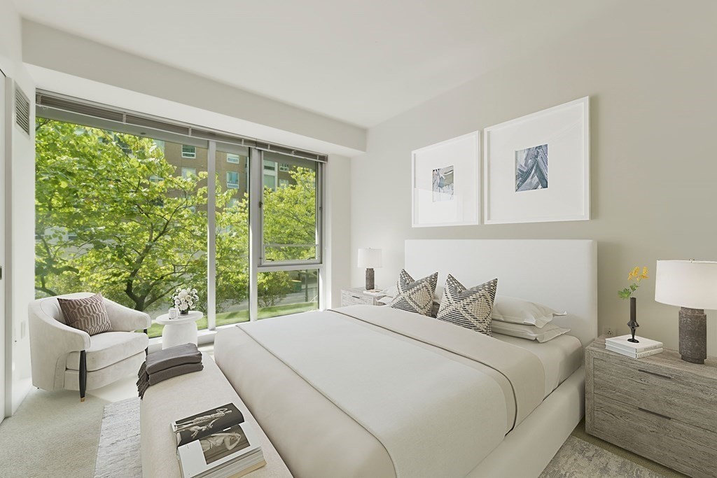 2 Earhart Street, Unit 120 Cambridge, MA 02141 - Photo 16 of 42 a bedroom with furniture and a large window