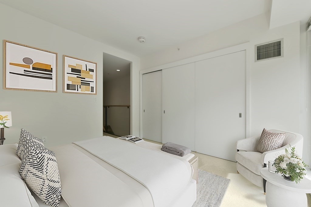 2 Earhart Street, Unit 120 Cambridge, MA 02141 - Photo 17 of 42 a bedroom with a bed and a painting on the wall