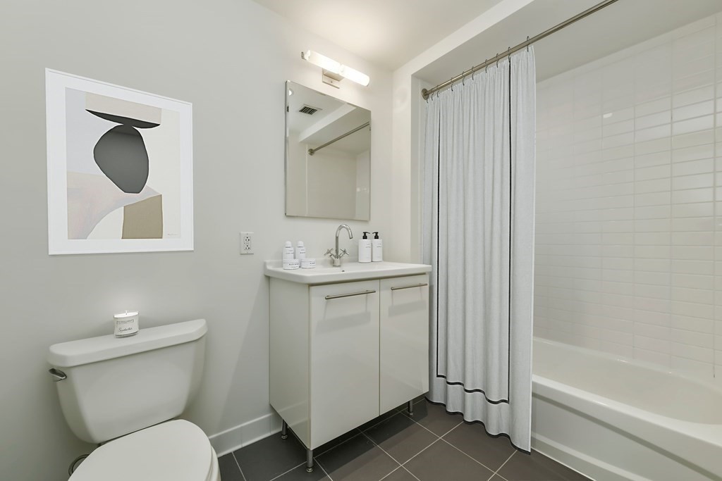 2 Earhart Street, Unit 120 Cambridge, MA 02141 - Photo 18 of 42 a bathroom with a toilet sink and mirror