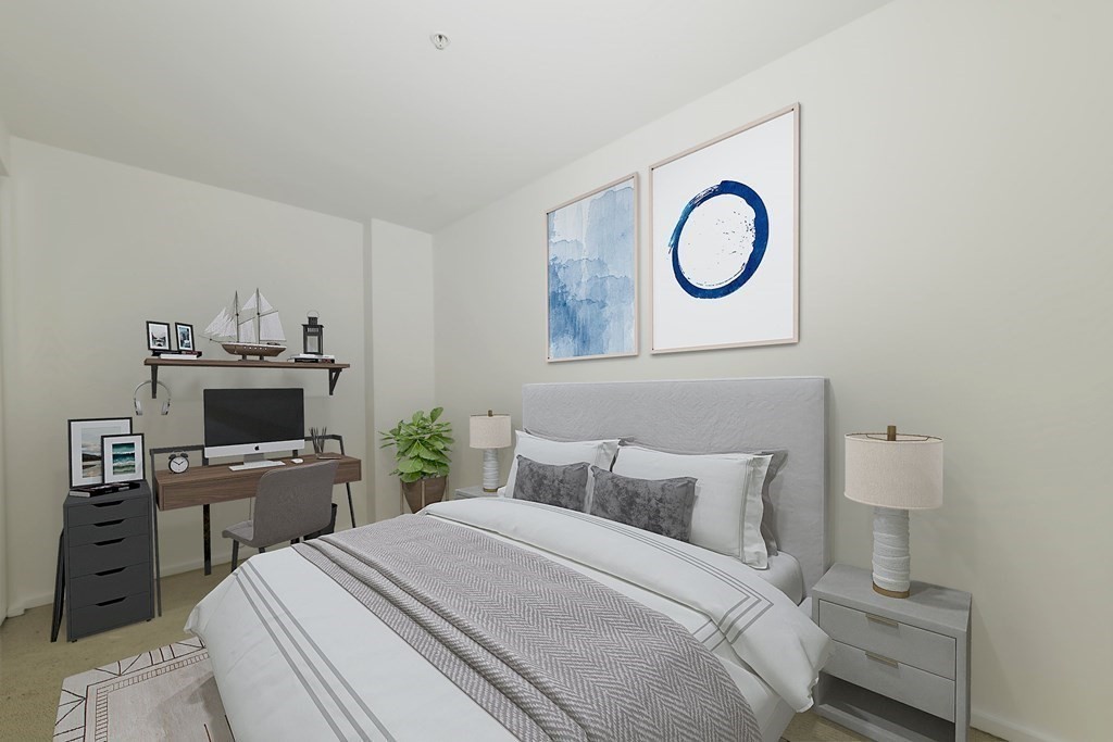 2 Earhart Street, Unit 120 Cambridge, MA 02141 - Photo 20 of 42 a bedroom with a bed and a flat tv screen on the dresser