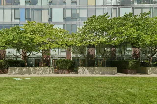 a front view of a building with a garden