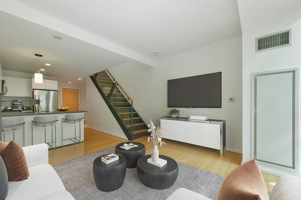 2 Earhart Street, Unit 120 Cambridge, MA 02141 - Photo 4 of 42 a living room with furniture and a flat screen tv