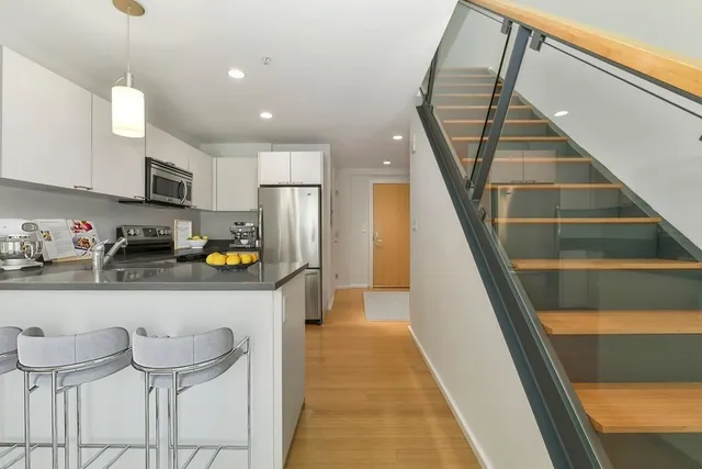 a kitchen with stainless steel appliances granite countertop a refrigerator and microwave
