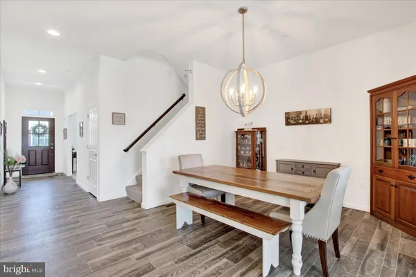 a large kitchen with stainless steel appliances granite countertop a stove a sink dishwasher and a refrigerator with wooden floor