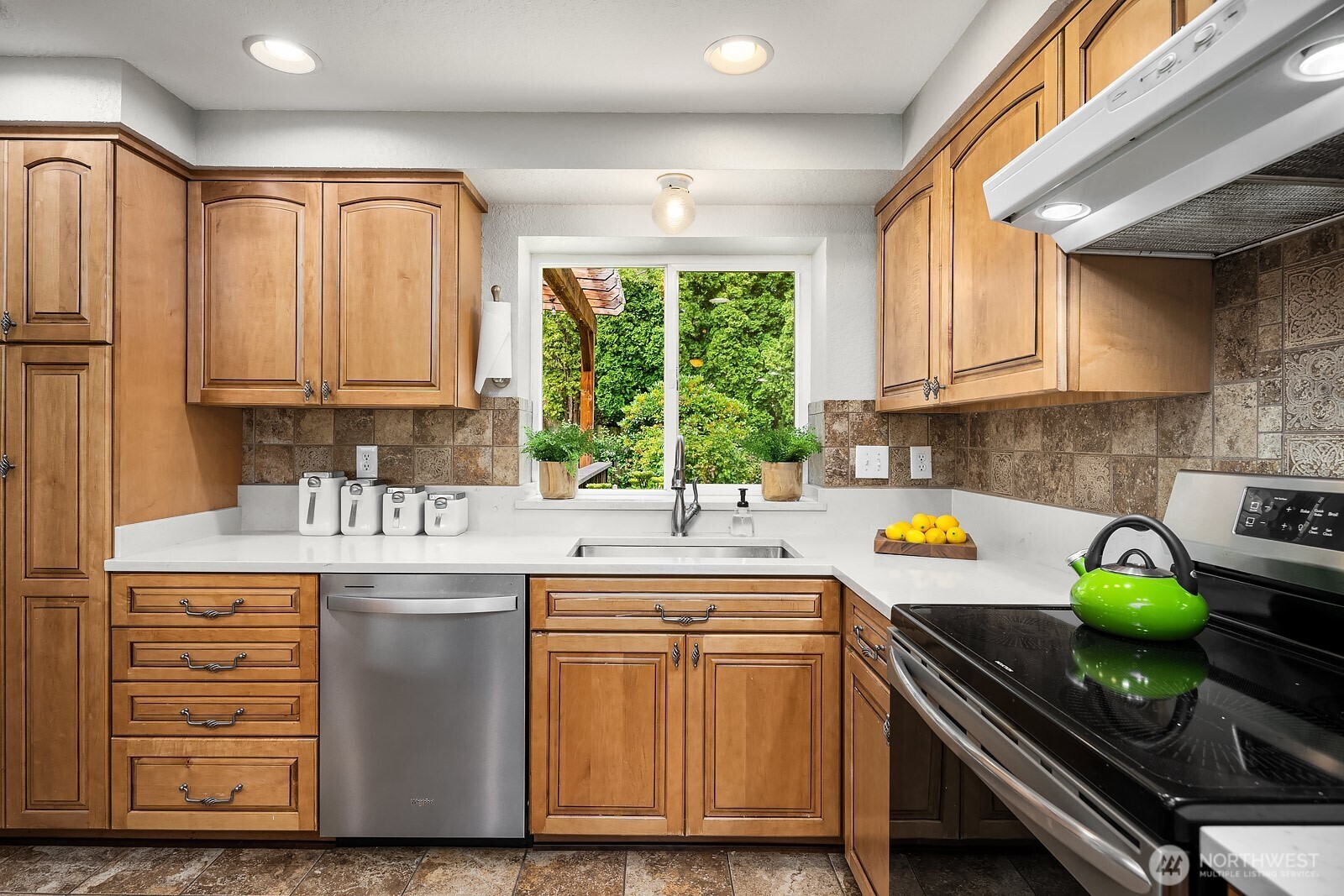 409 169th Street Southeast Bothell, WA 98012 - Photo 8 of 31 a kitchen with stainless steel appliances granite countertop a sink a stove a counter space and cabinets