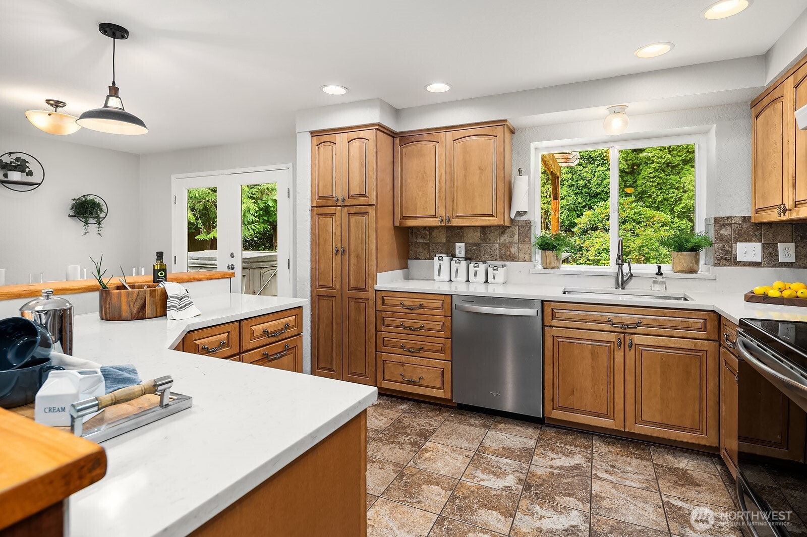 409 169th Street Southeast Bothell, WA 98012 - Photo 9 of 31 a kitchen with stainless steel appliances granite countertop a sink a stove and a refrigerator