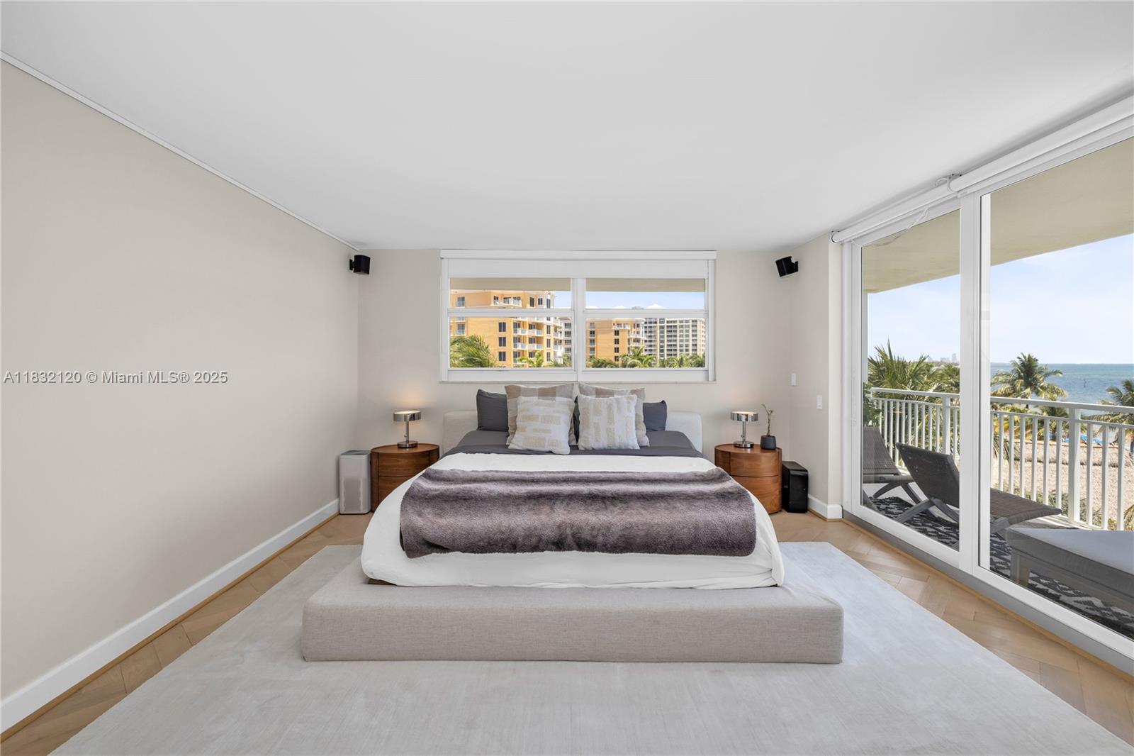 615 Ocean Drive, Unit 6A Key Biscayne, FL 33149 - Photo 11 of 40 a spacious bedroom with a bed and glass door