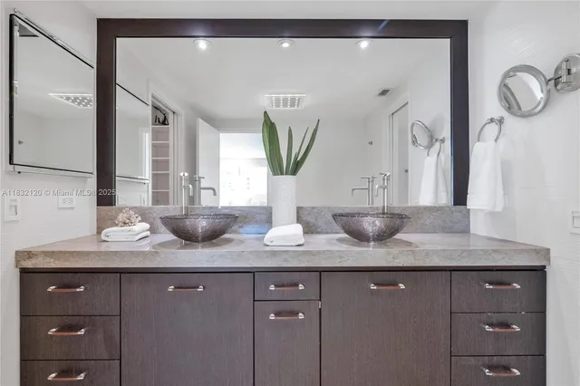 a bathroom with a granite countertop sink a large mirror and vanity