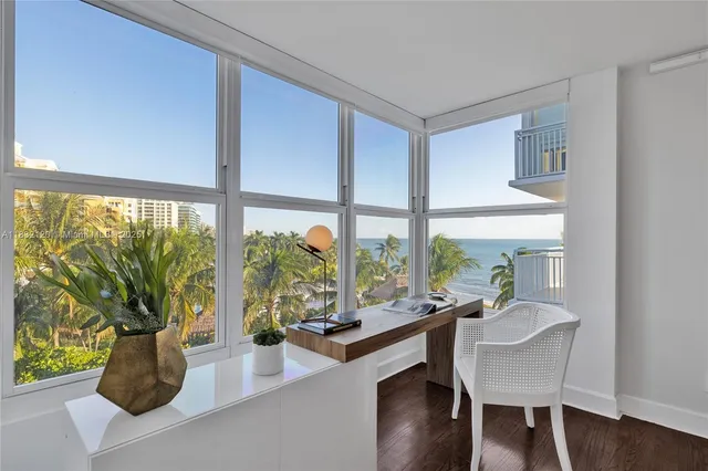a dining room with wooden floor and a potted plant
