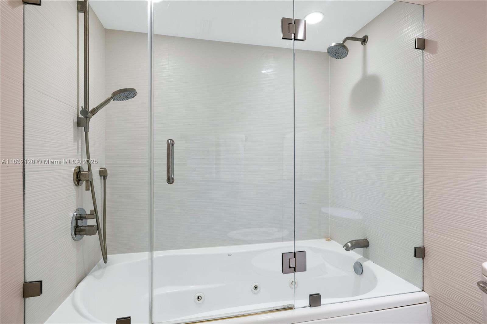 615 Ocean Drive, Unit 6A Key Biscayne, FL 33149 - Photo 24 of 40 a white bath tub and shower