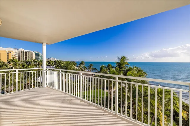 a view of a balcony with wooden fence and floor