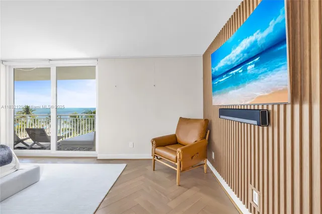 a living room with furniture and a floor to ceiling window