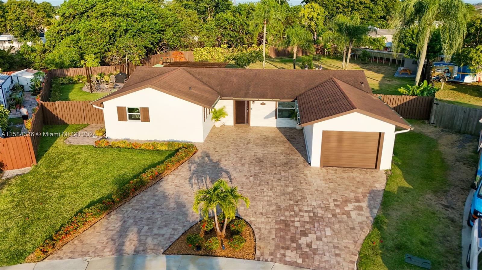 10300 Sleepy Brook Way Boca Raton, FL 33428 - Photo 37 of 41 a front view of a house with garden