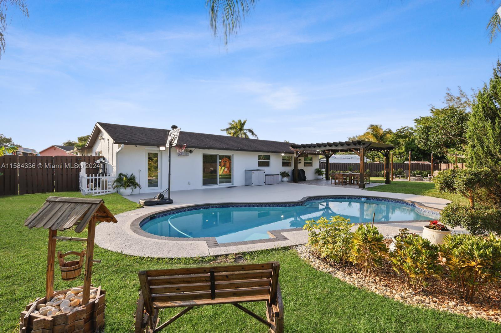 10300 Sleepy Brook Way Boca Raton, FL 33428 - Photo 5 of 41 a swimming pool with outdoor seating and yard