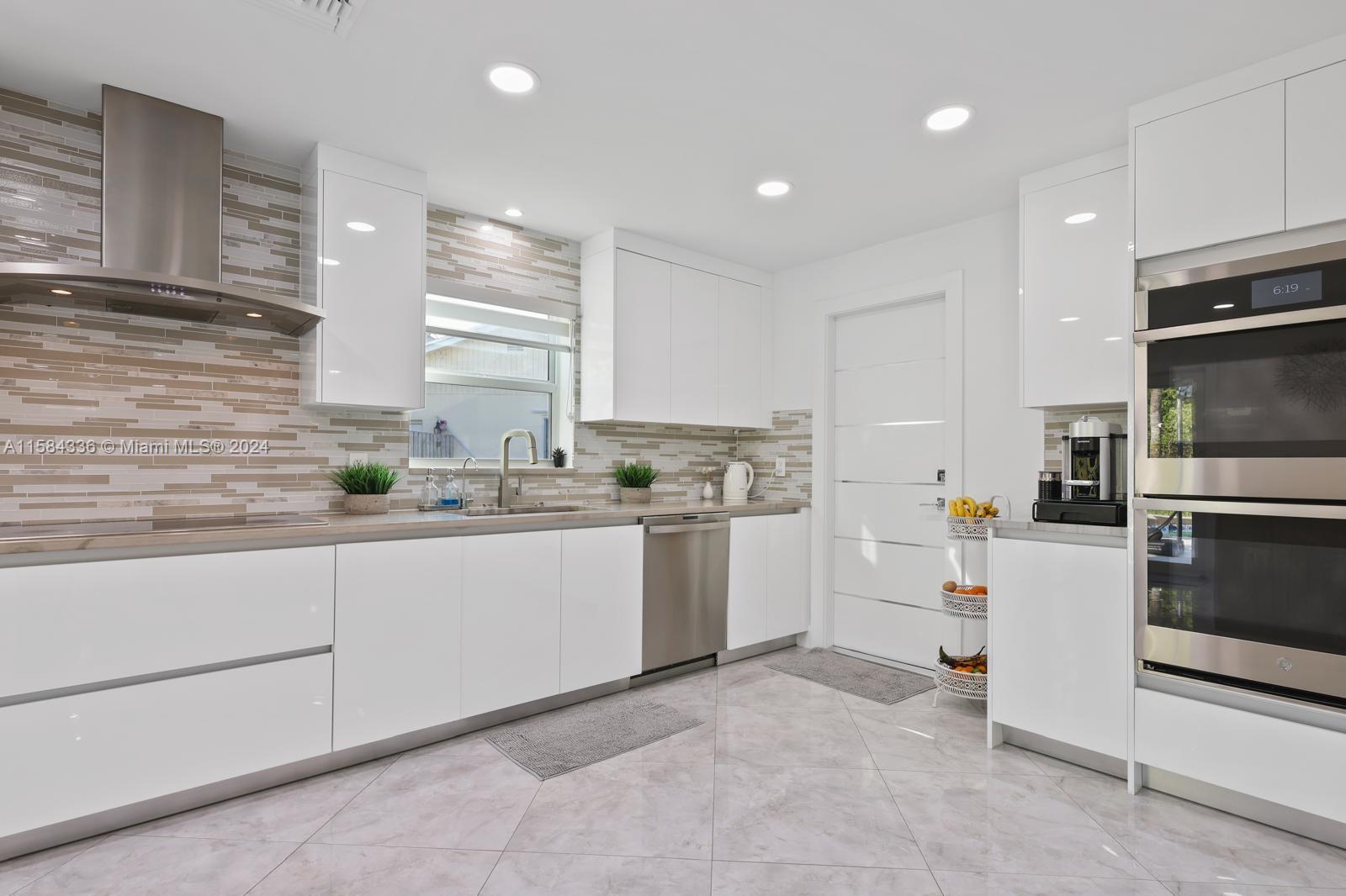 10300 Sleepy Brook Way Boca Raton, FL 33428 - Photo 7 of 41 a kitchen with granite countertop white cabinets and white appliances