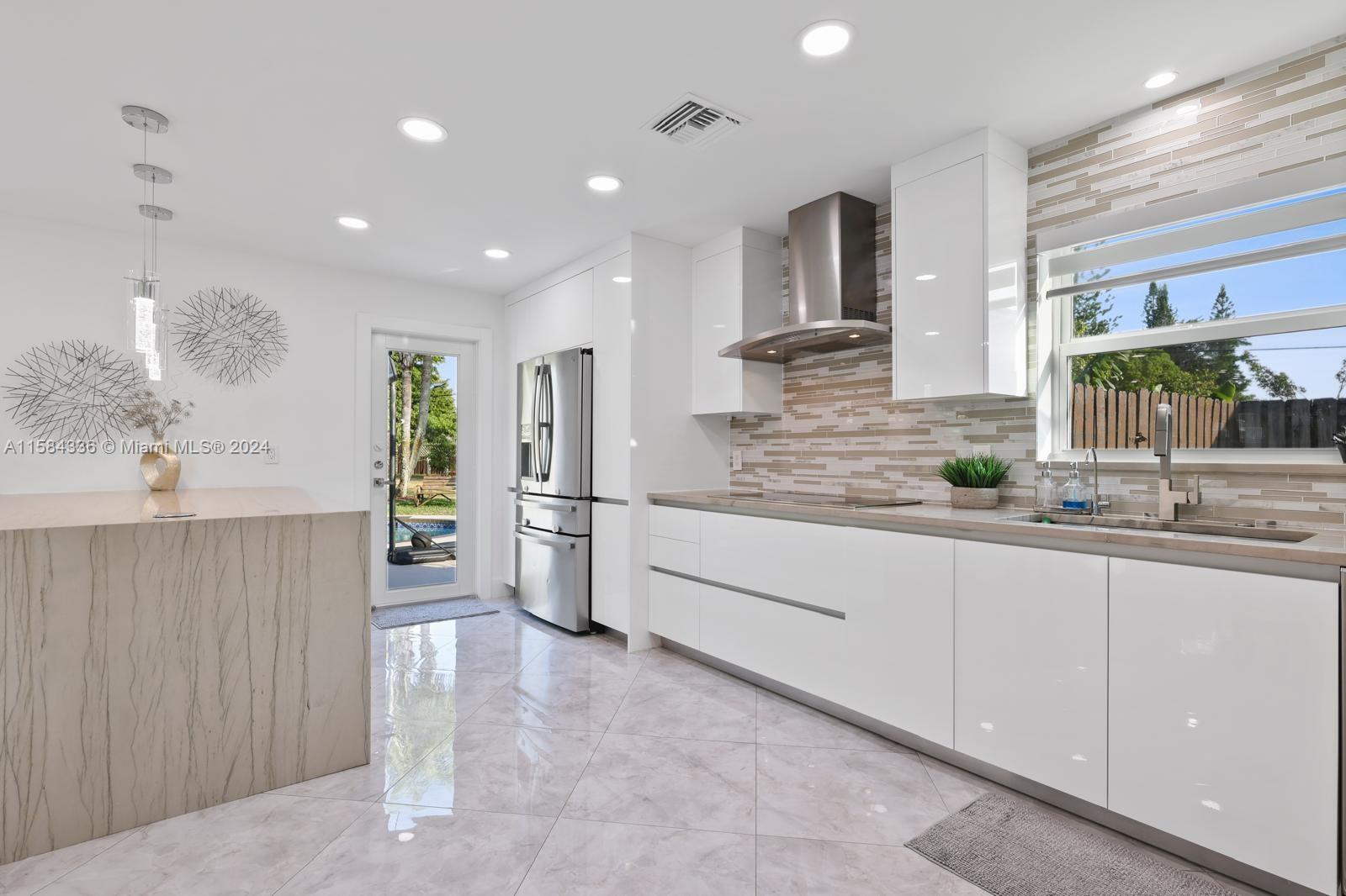 10300 Sleepy Brook Way Boca Raton, FL 33428 - Photo 8 of 41 a large kitchen with granite countertop a sink and white cabinets